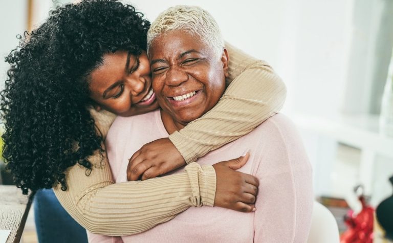 young woman hugs her mother